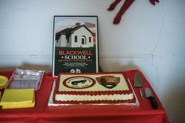 A cake with the Blackwell School Alliance horse logo and National Park Service logo