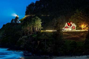 The heceta lighthouse inn in Florence, Oregon glowing at night